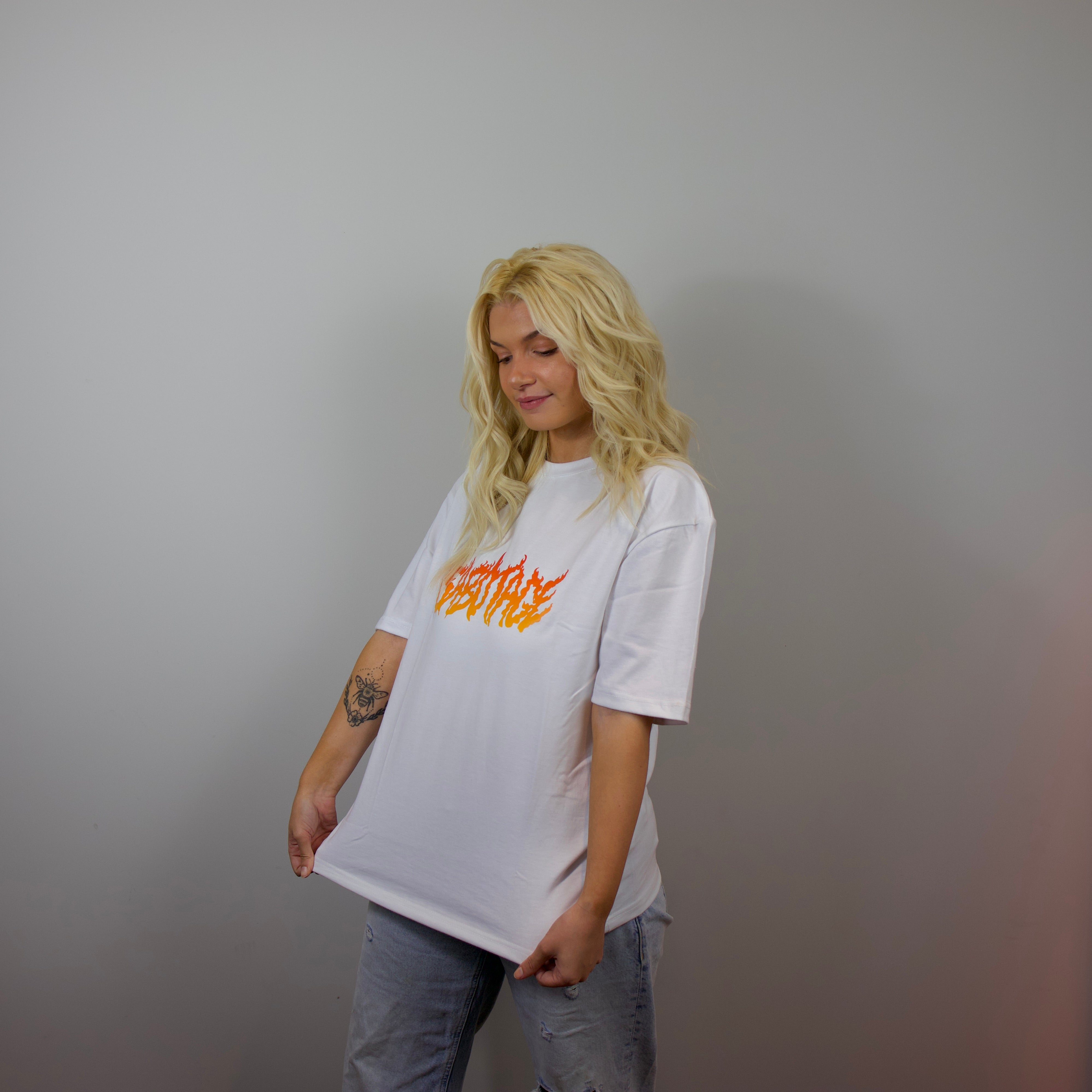 Premium streetwear model in luxury fire t-shirt detail fire logo shot