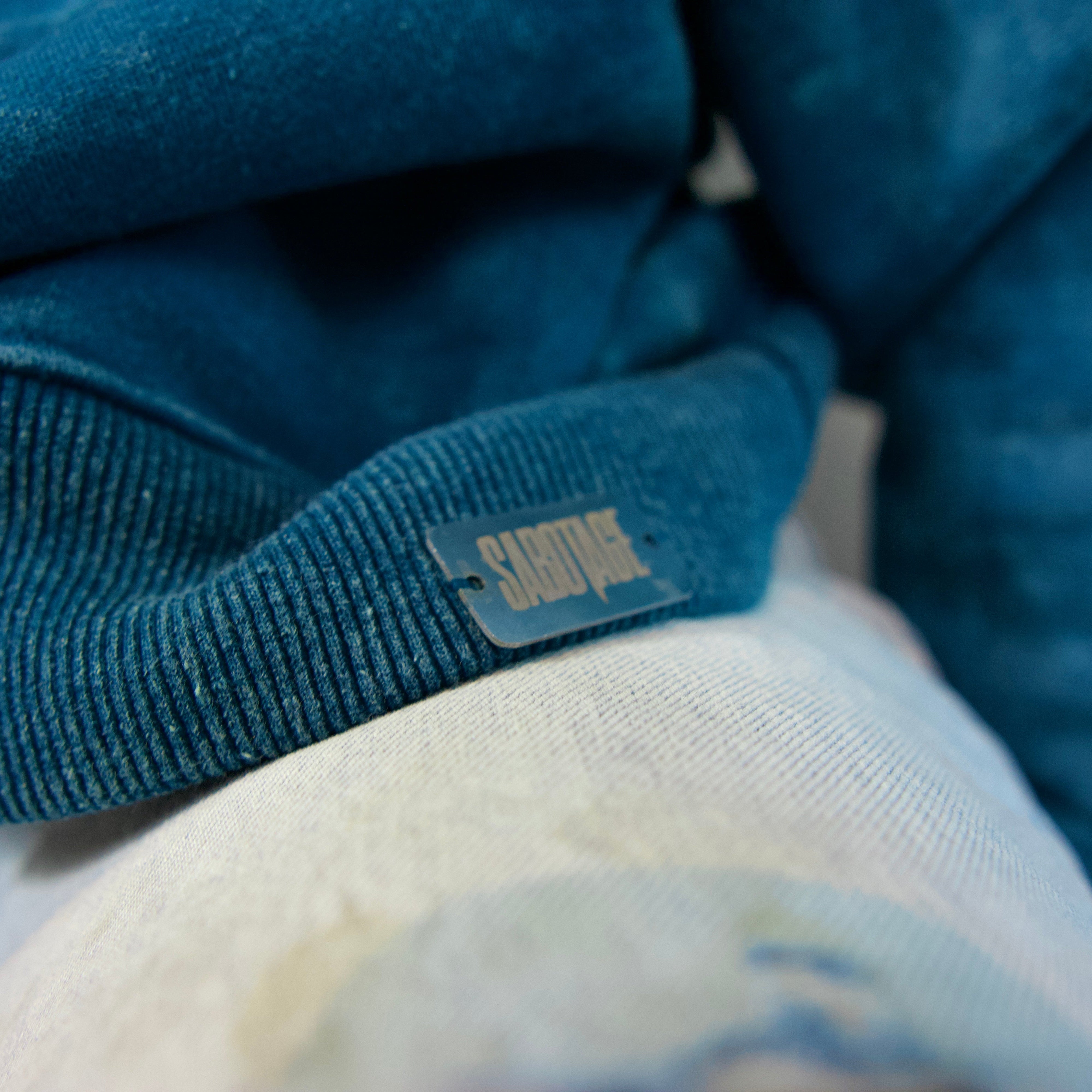 Premium streetwear metal badge detail shot of luxury great events sweatshirt