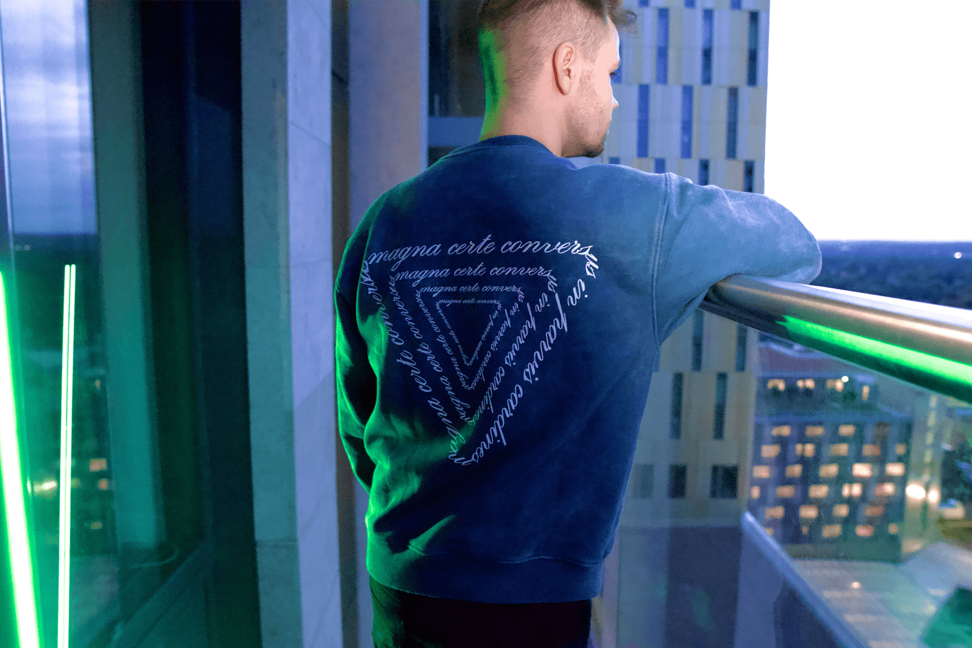 Back shot of man wearing teal sweatshirt